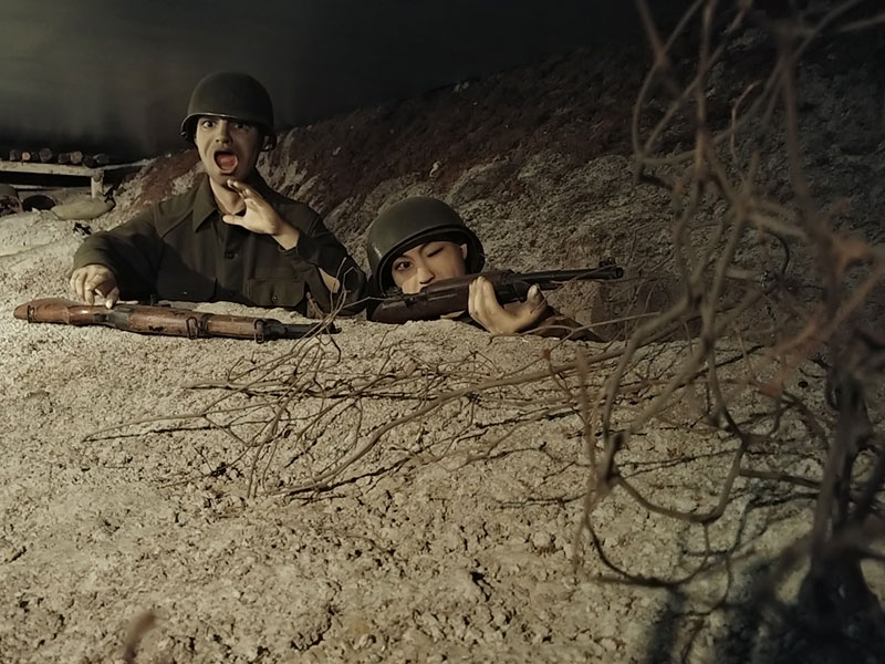 Two mannequin US Army soldiers looking out of a bunker as part of an exhibit at the 2nd Infantry Division Museum.